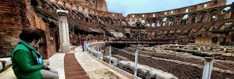 A teenager sits in the Colosseum in Rome