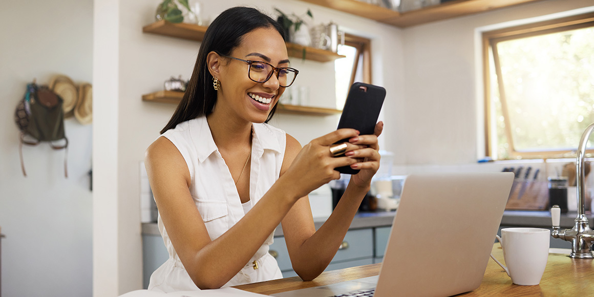 Smiling sales member getting a text about lead activity from a HubSpot workflow