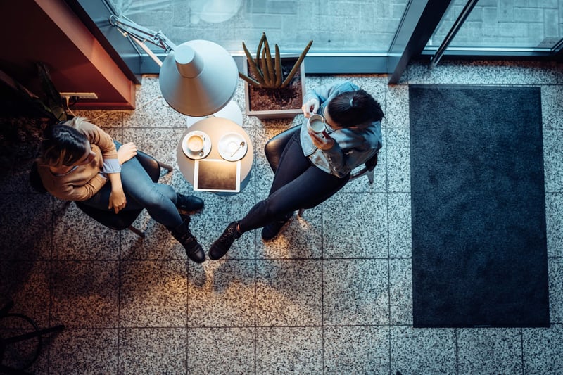Two women enjoying coffee shot from above