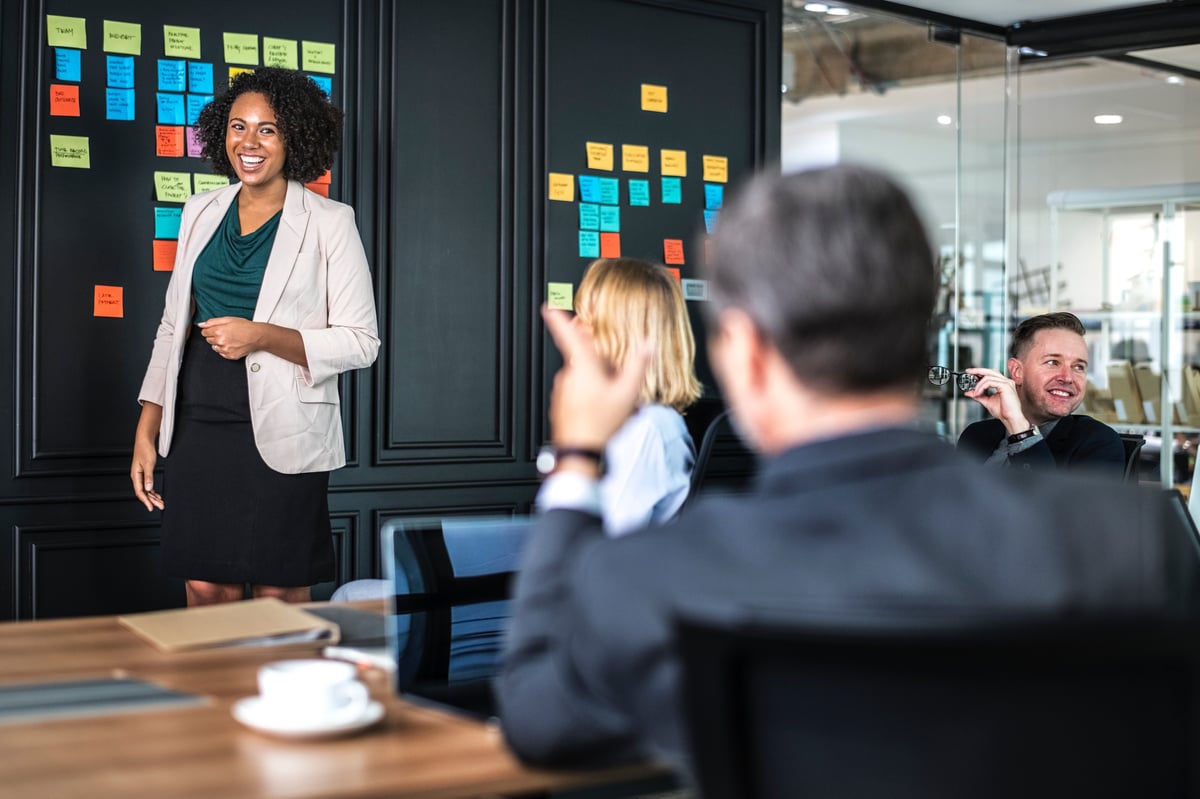 Woman presenting to group at the office