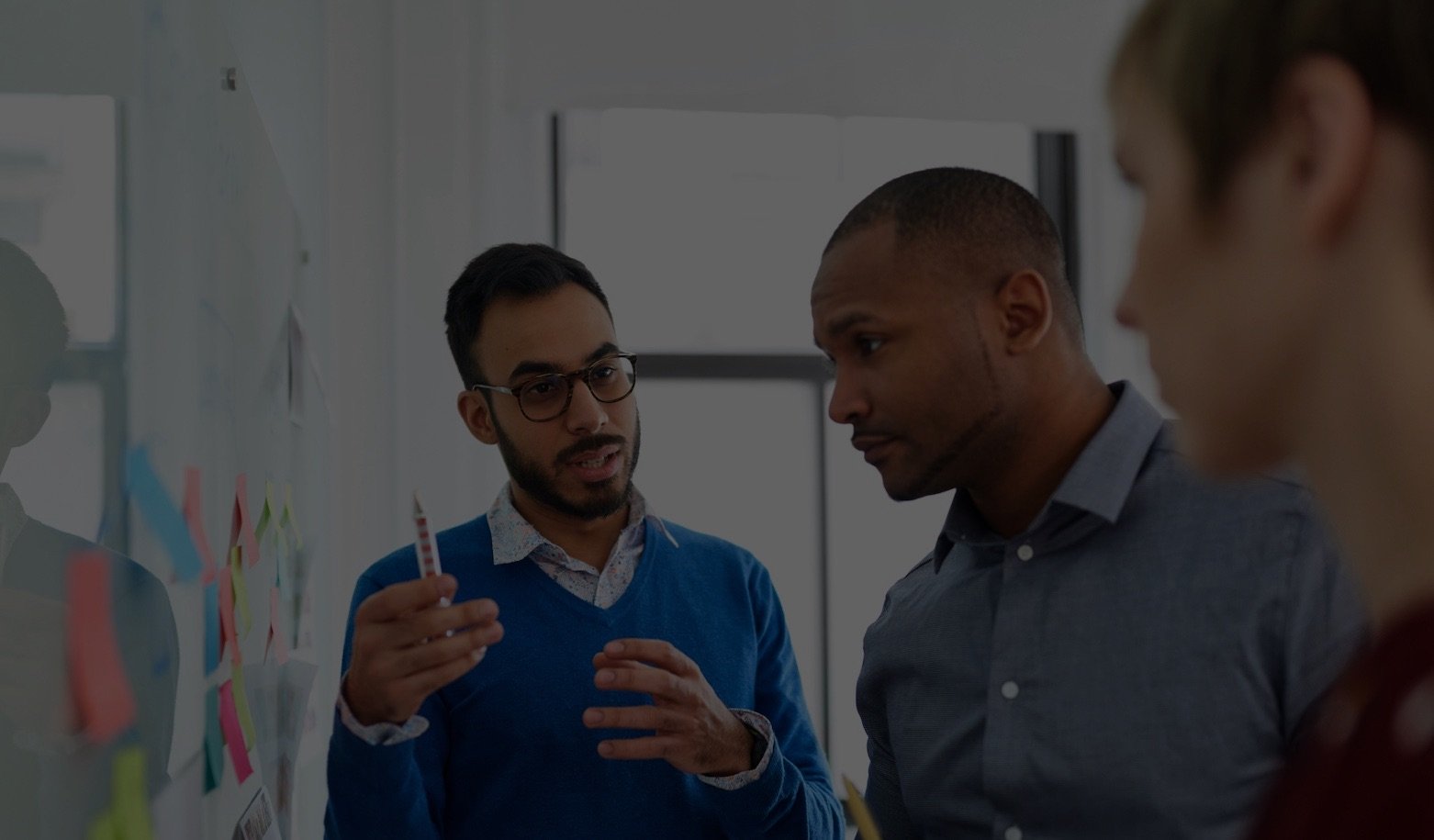 Three employees strategizing