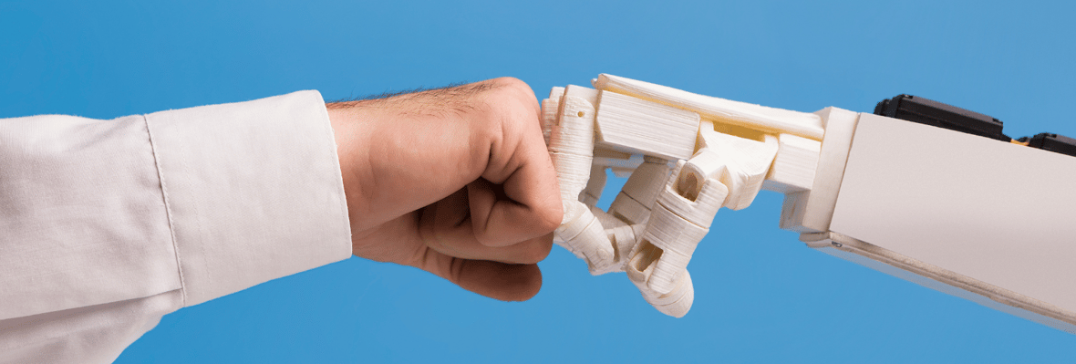 A human hand fist bumping a robot hand