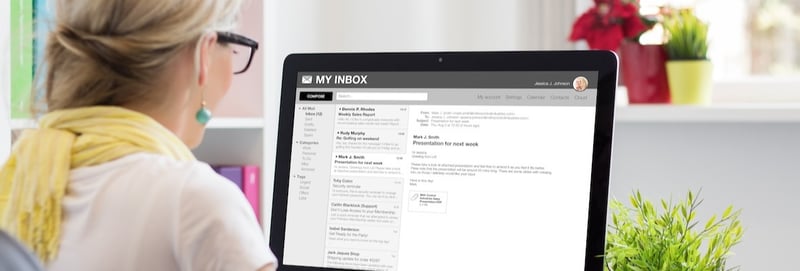 Businesswoman reading email on computer.