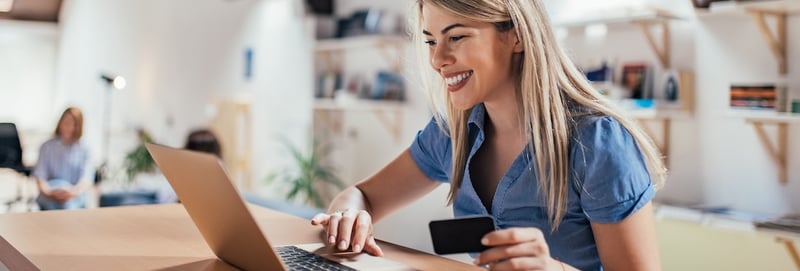 Happy young woman doing e-shopping
