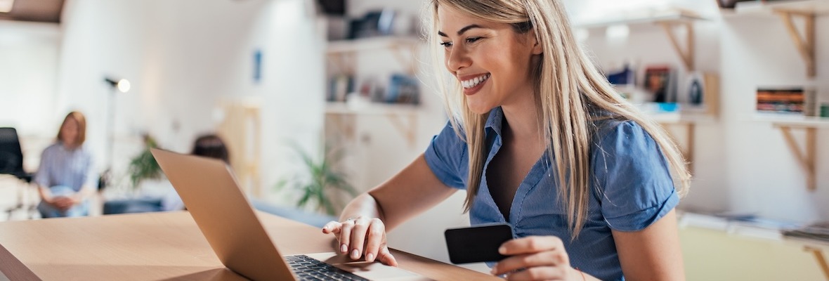 Happy young woman doing e-shopping