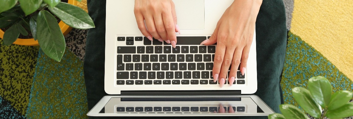 Laptop with the hands of a woman typing