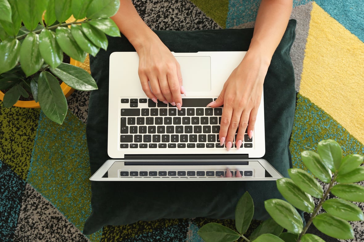 Laptop with the hands of a woman typing