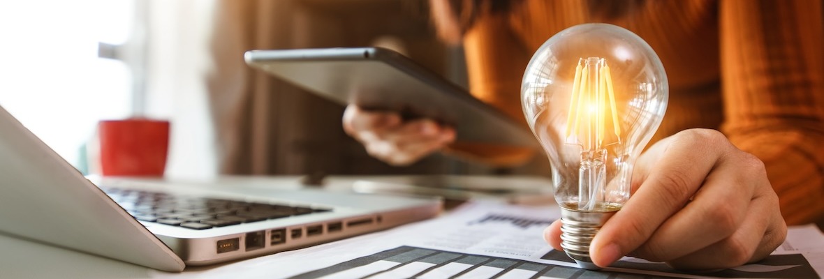 business hand showing creative business strategy with light bulb as concept