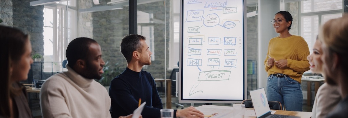 Colleagues Sit Behind Conference Table and Discuss Business Development, User Interface and Design.