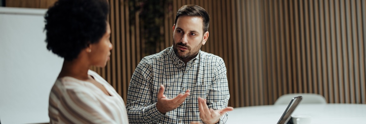 Colleagues Sit Behind Conference Table and Discuss Business Development