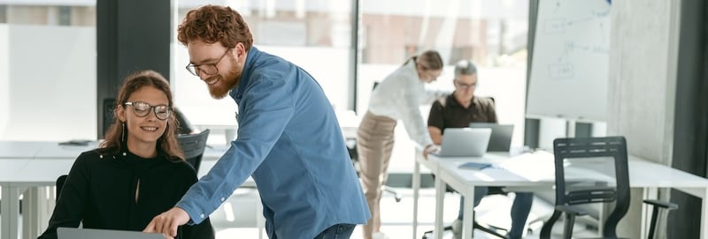 Two diverse business colleagues disscuss biz issue while use laptop in office background