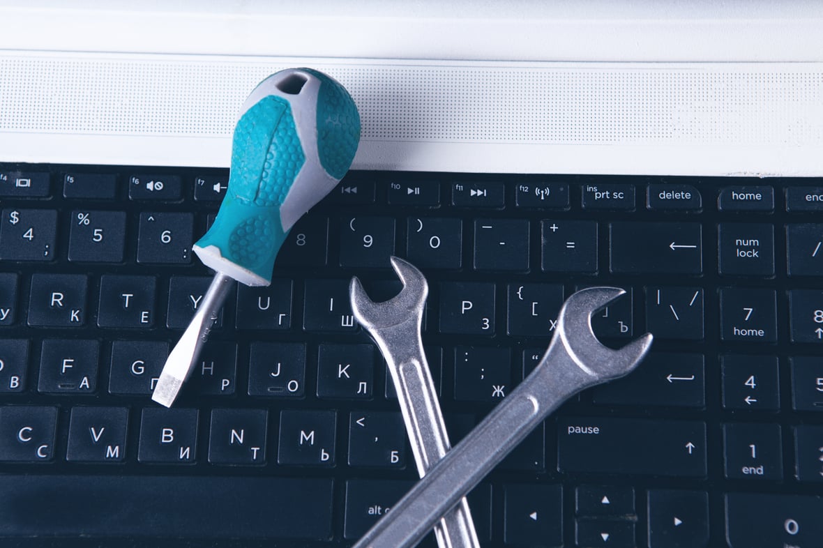 Image of a keyboard with tools on top of it