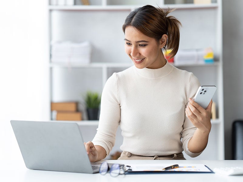 Asian woman working with laptop in her office