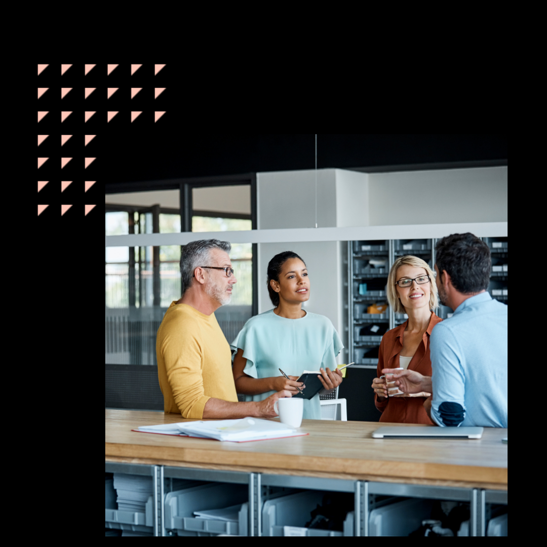 Executives discussing at desk in textile factory