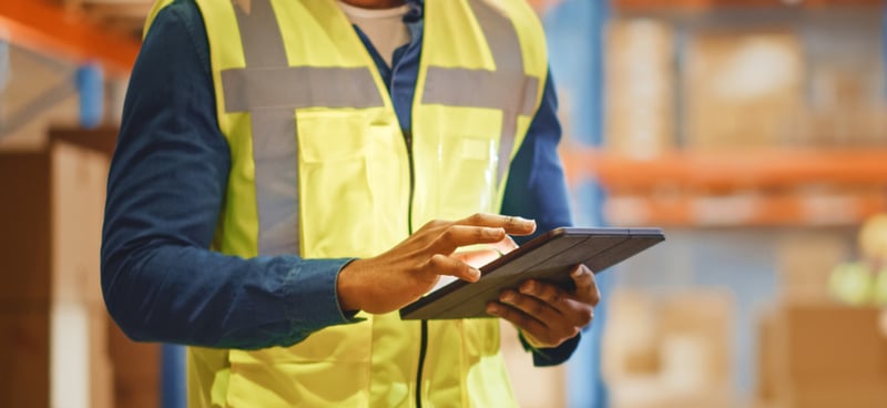 Warehouse worker checking inventory on ipad