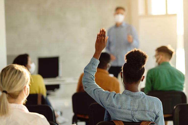 higher ed student raising hand
