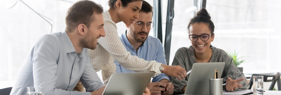 A group of employees review HubSpot's Operations Hub on a laptop. 