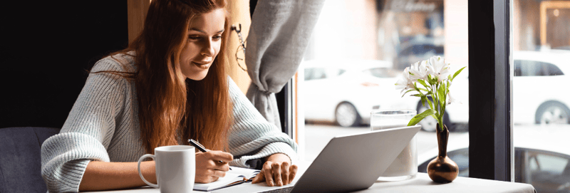 A woman writes down a list of ways to repurpose webinar content. 