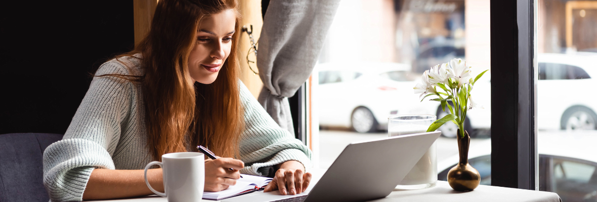 A woman writes down a list of ways to repurpose webinar content. 