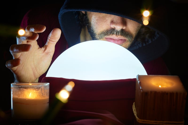 SEO predictions man with hand over glass orb and lit candles