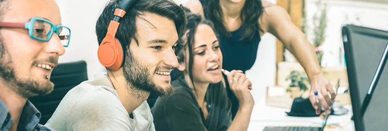 Group of coworkers analyzing data of the computer