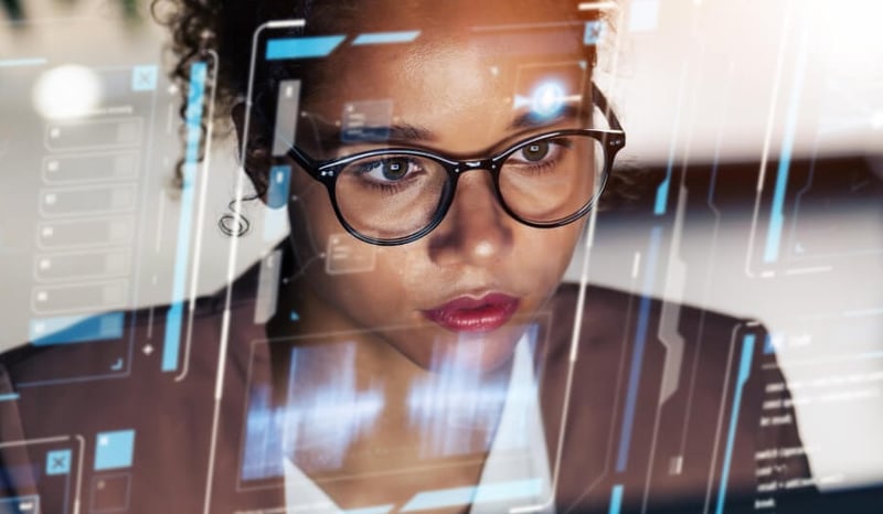 Close up image of a woman looking through a computer screen