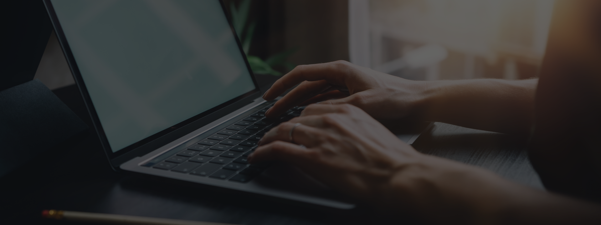 Person typing on laptop keyboard