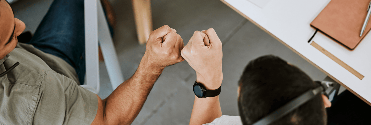 Close up image of two co-workers fist bumping