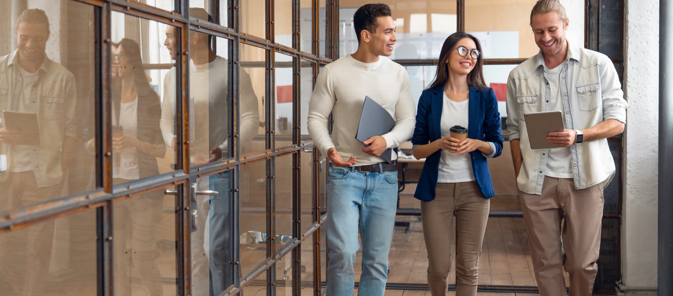 Group of marketers walking down the hallway of an office