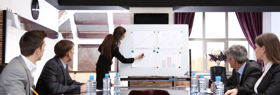 A group of professionals receiving a training on a meeting room