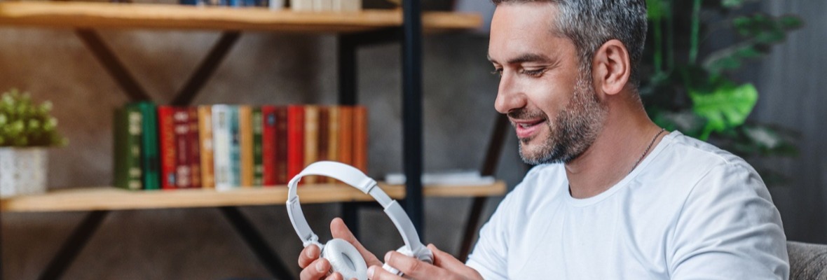 Man looking at his headphones