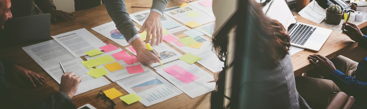 overhead shot of paperwork with post it notes