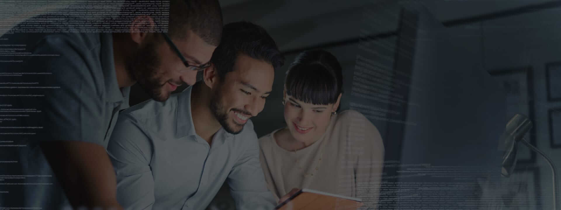 Three employees gathered around a tablet.