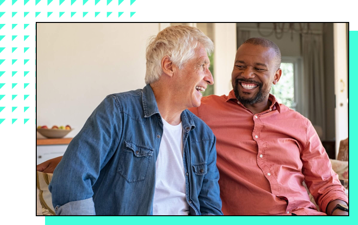 two senior men laughing together
