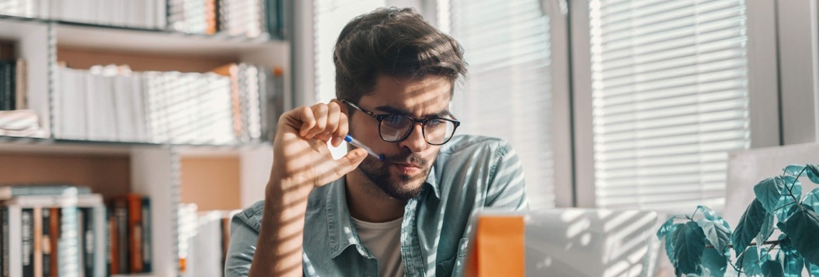 Man sitting in front of his computer analyzing information