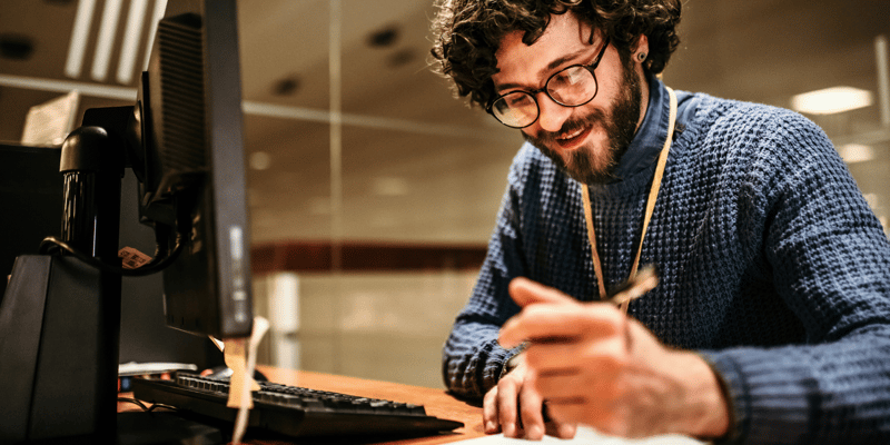 Man writing at his desk