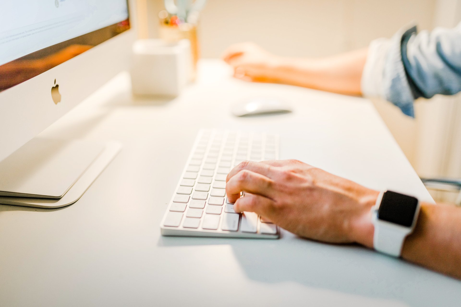 Hands typing on a keyboard