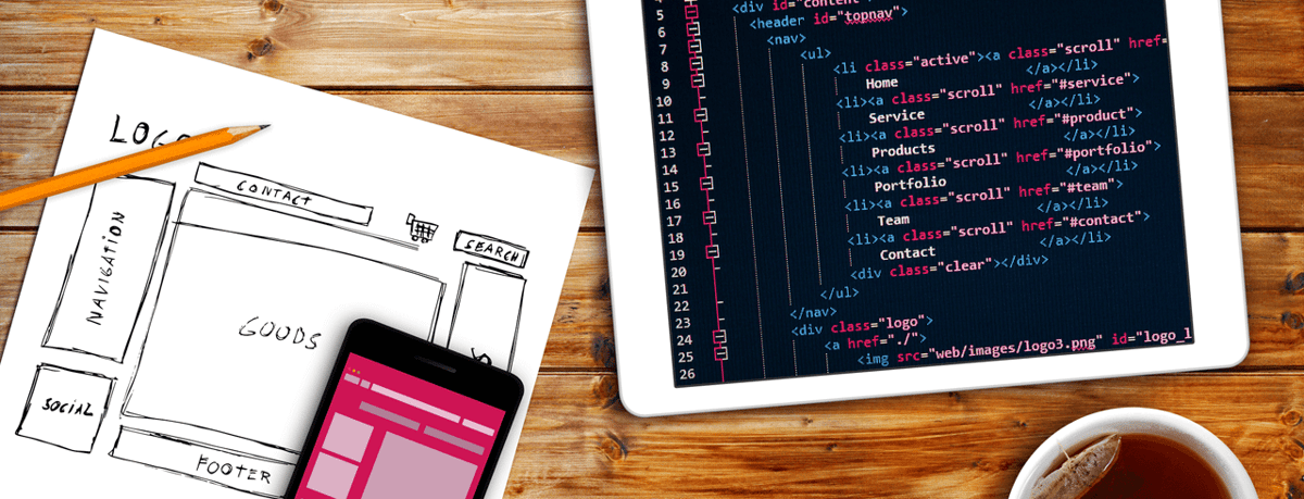 overhead shot of wireframe and tablet with code