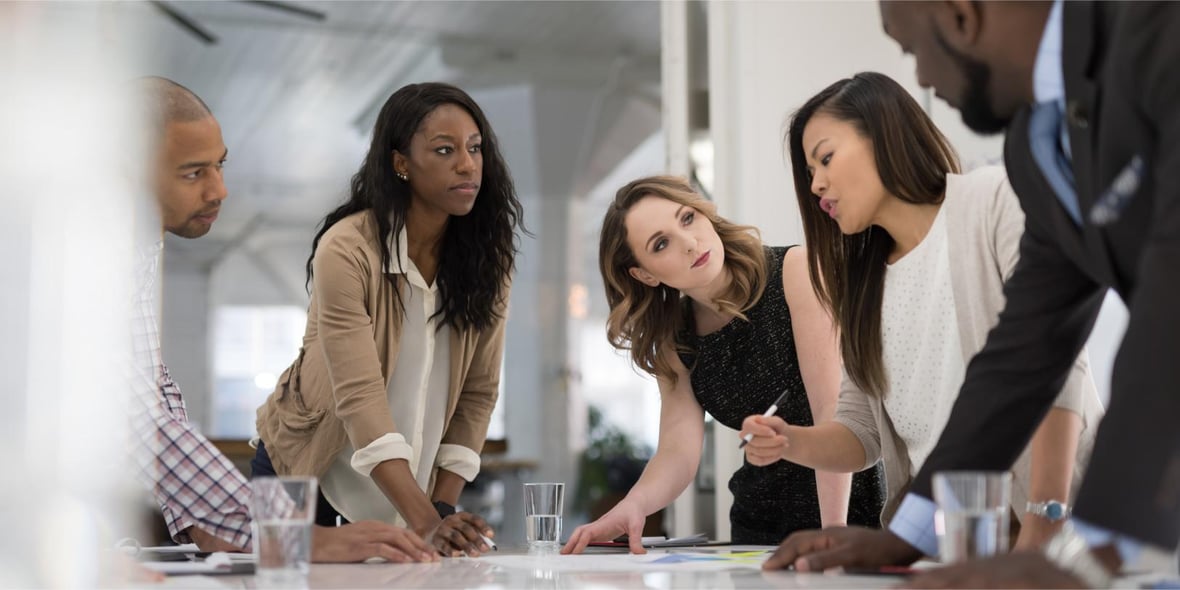 A group of marketers discussing business strategies in an office