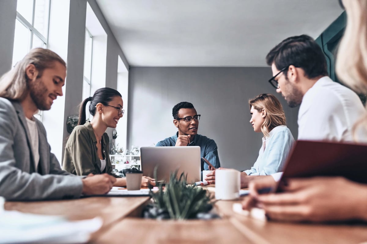 a group of employees in a meeting