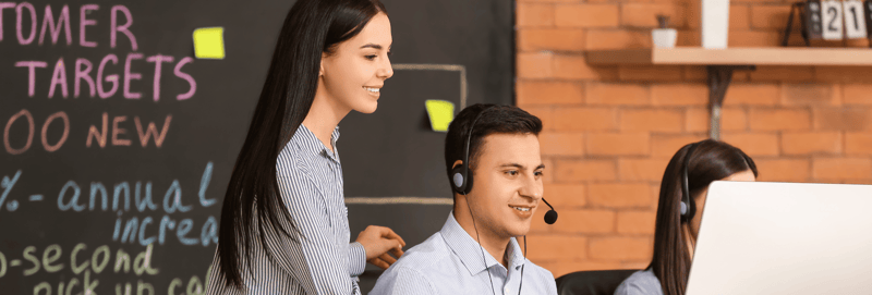 Two marketers working together at a computer