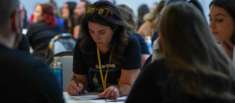 SmartBug female employee strategizing over a table