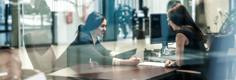 a marketing consultant showing some paperwork to her client