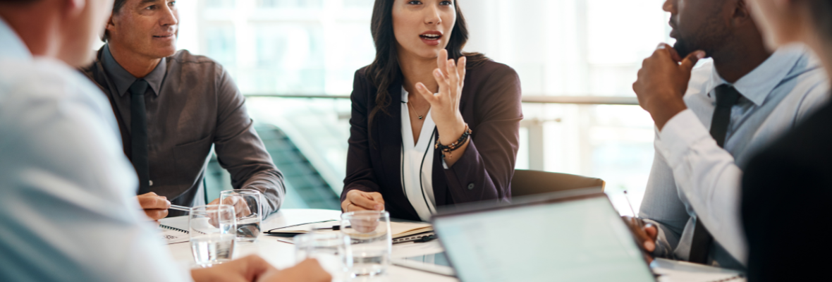 A group of five marketers gathered at a work table