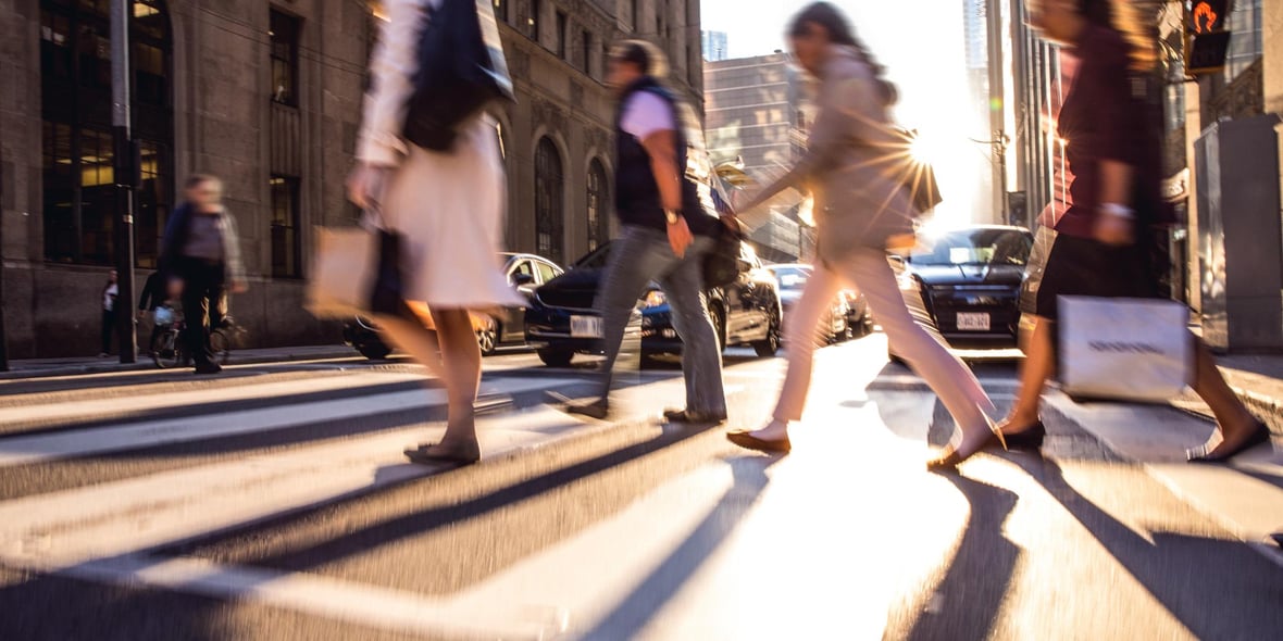 People crossing a street in a city with fast moving effect