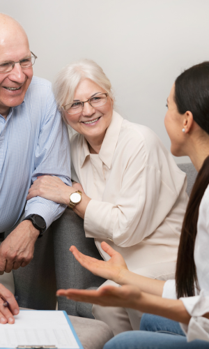 Two senior citizens talking to a doctor