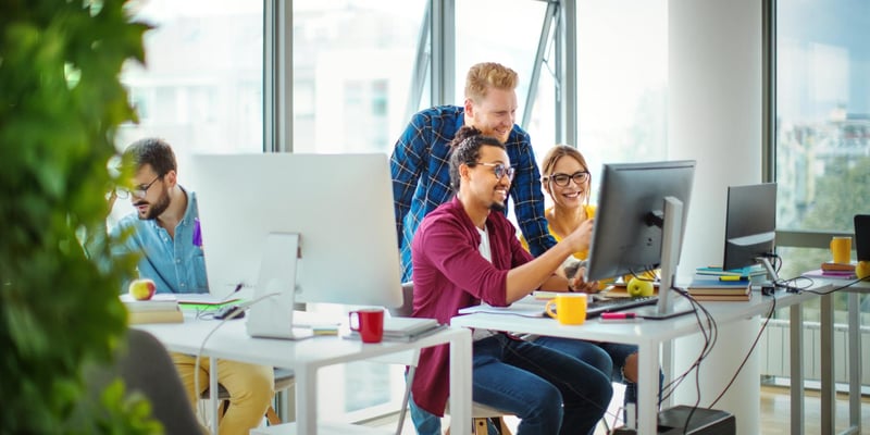 Three marketers working in their desk