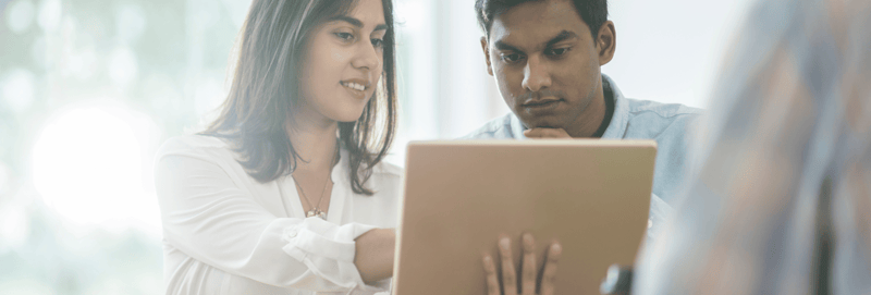 Two marketers looking over a tablet