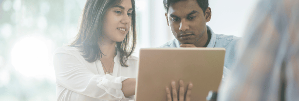 Two marketers looking over a tablet