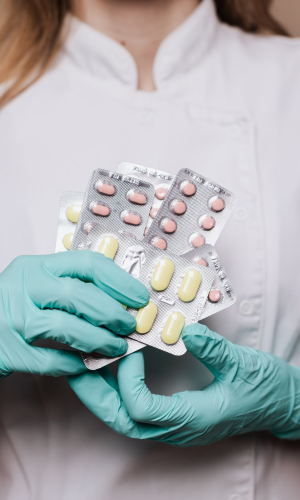 a doctor holding multiple pills